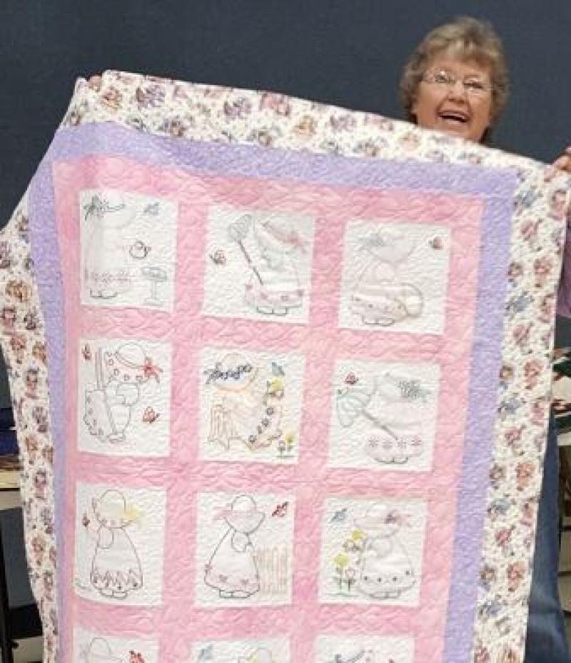 Shirley shows a Sunbonnet Sue child's quilt with hand embroidered blocks